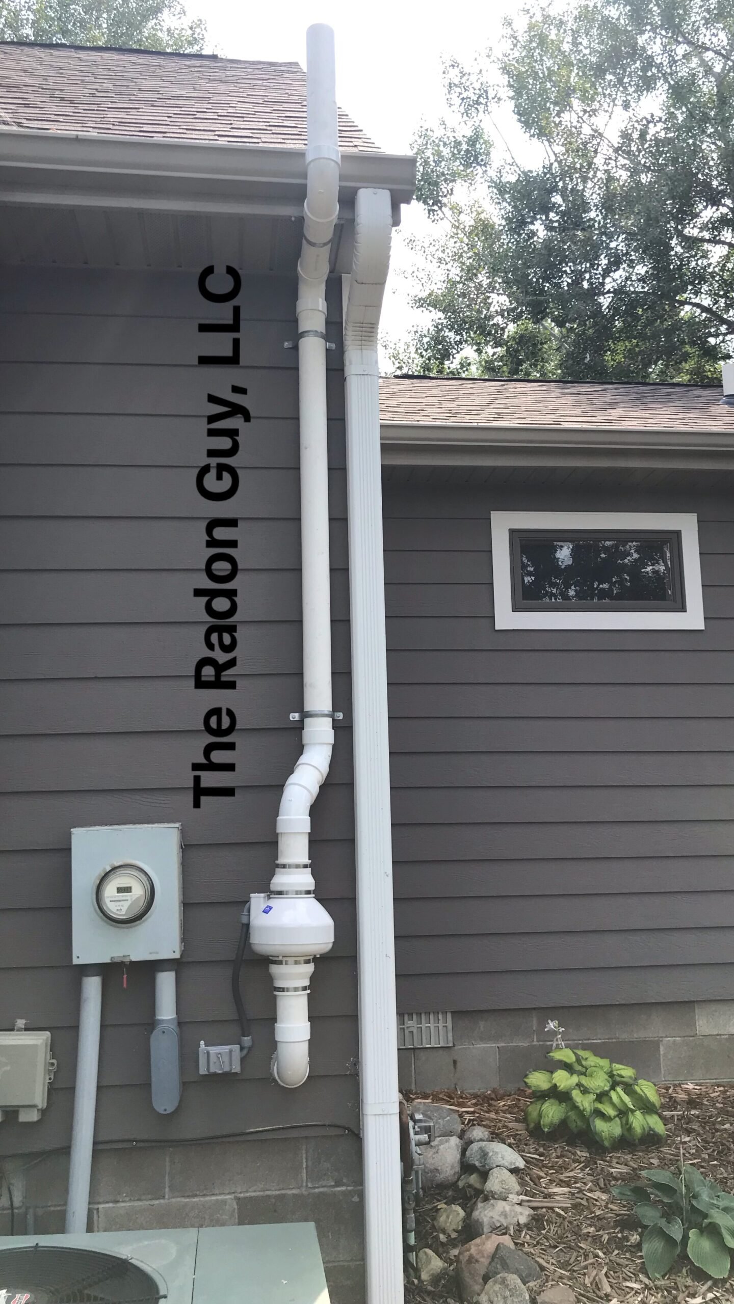 Exterior radon mitigation system installed by The Radon Guy. 